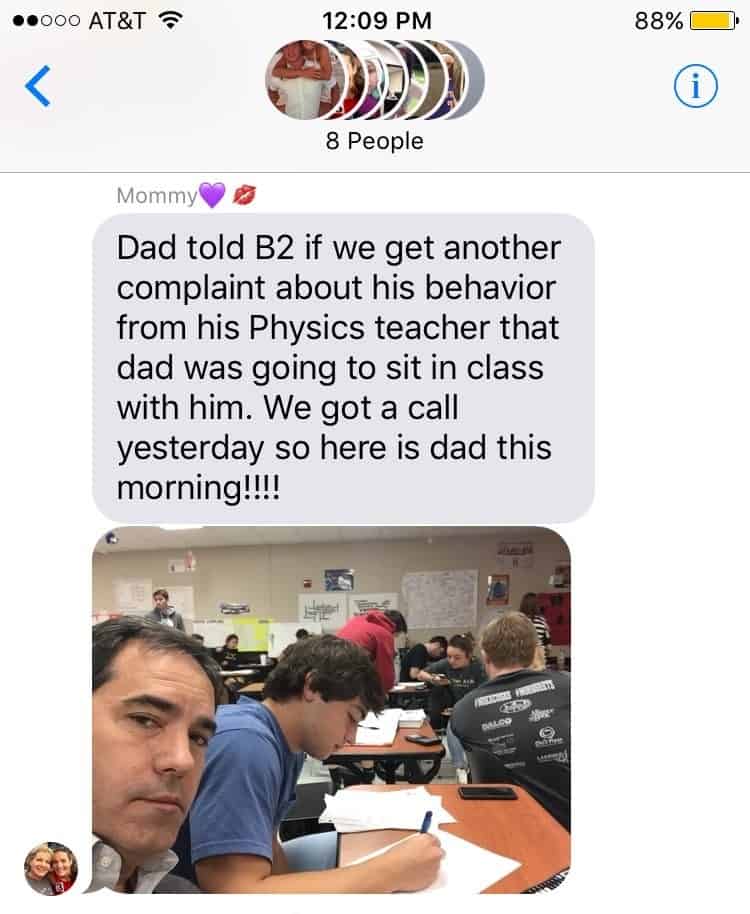 dad sits with son in class