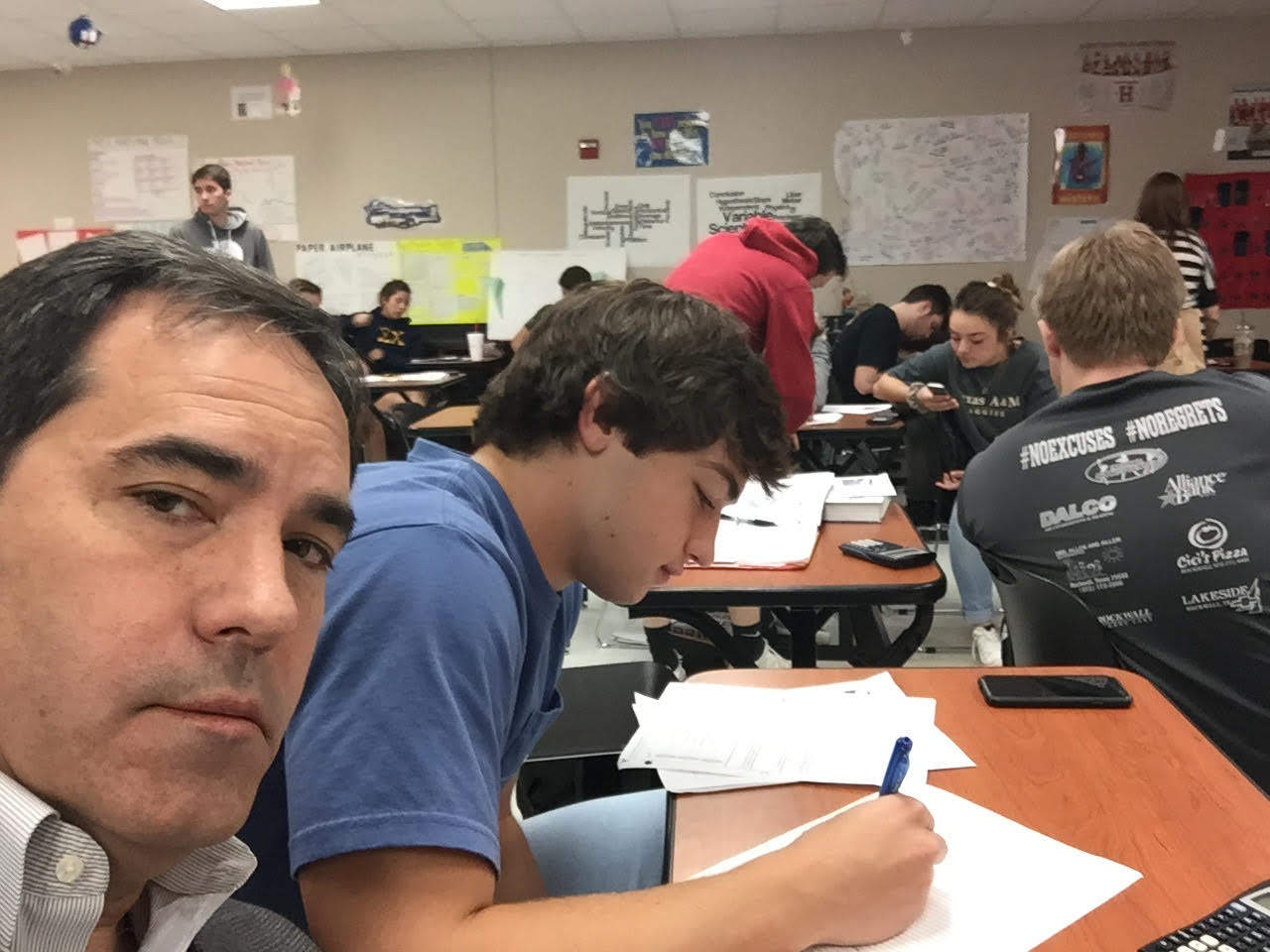 dad sits with son in class