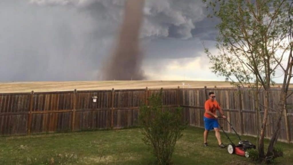 man mowing lawn tornado